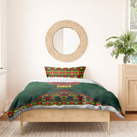 Green bedding set on wooden bed frame with colorful Mexican folk comforter and pillowcases.