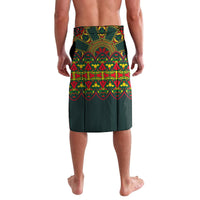 Green lavalava with bright embroidered-style Mexican folk bands, straight drape, knee-length.