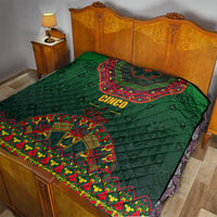Green quilt on bed with red-and-yellow folk medallion and 'Cinco Mayo' text