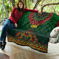 Green quilted throw draped with 'Cinco' text and colorful Mexican folk border