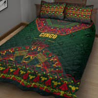 Green quilt bed set with Mexican folk motif and red accents; two matching pillows.