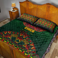 Green quilt bed set with colorful Mexican folk pattern and “Cinco de Mayo” lettering; pillows.