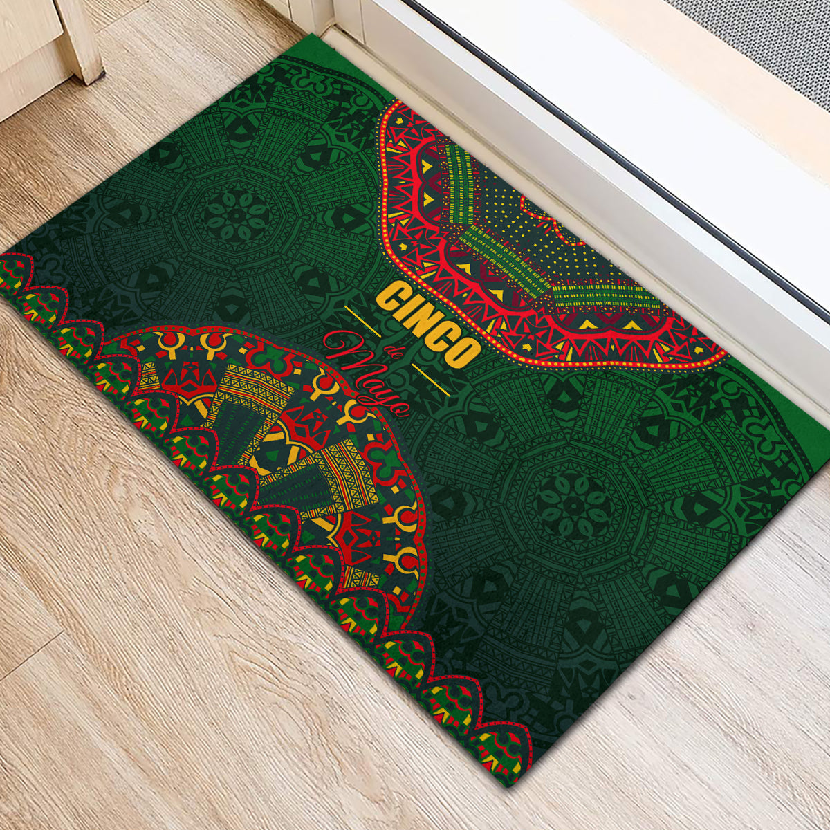 Green rubber doormat with Cinco de Mayo Mexican folk pattern, red and yellow text