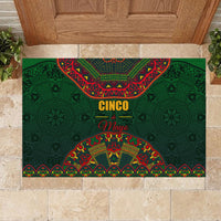 Green rubber doormat with centered Cinco de Mayo graphic and Mexican folk pattern