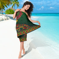 Green folk-pattern sarong with red trim and diagonal design panel