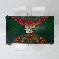 Green folk-pattern tablecloth with red and yellow decorative border and central motif