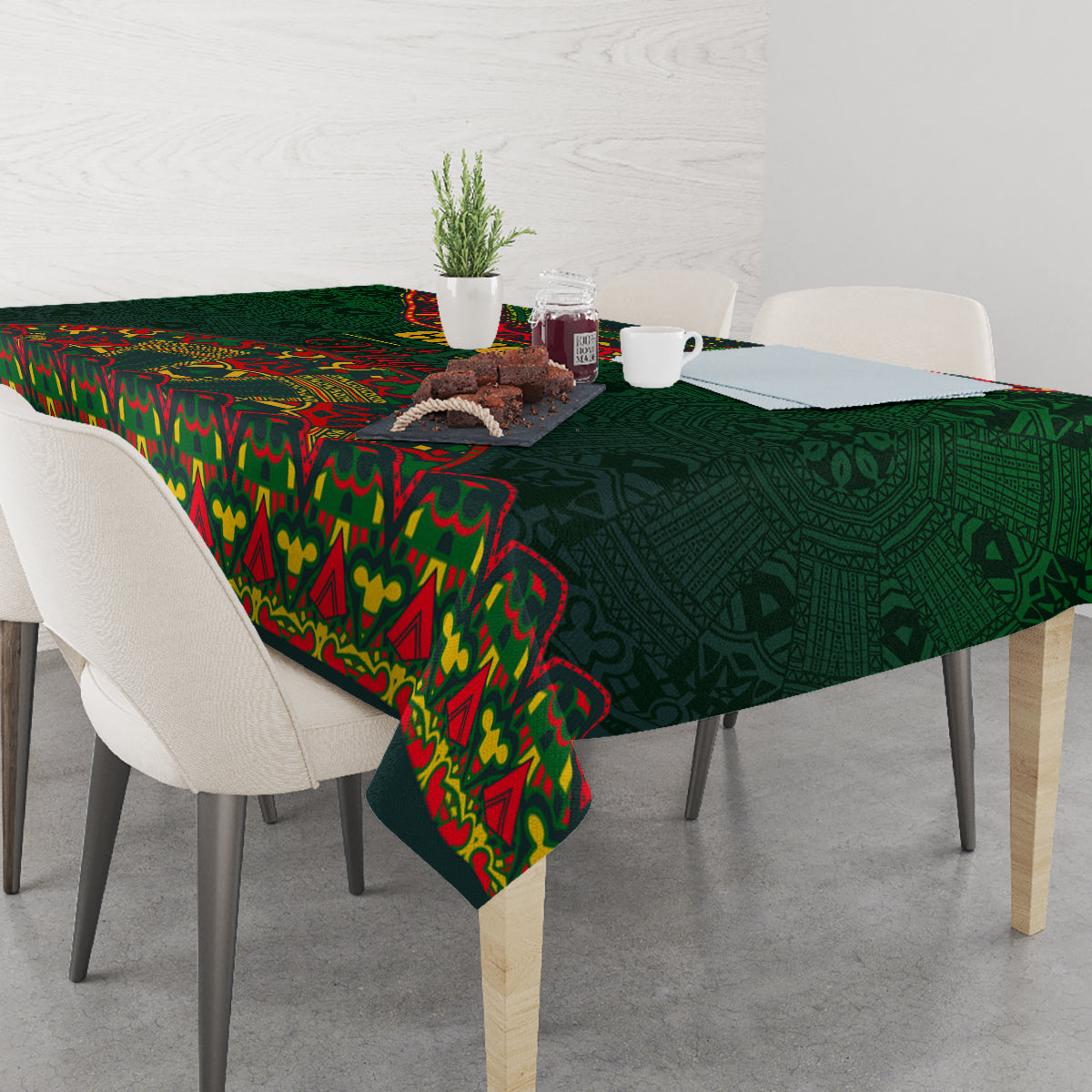 Green tablecloth with colorful folk motifs, draped across a dining table