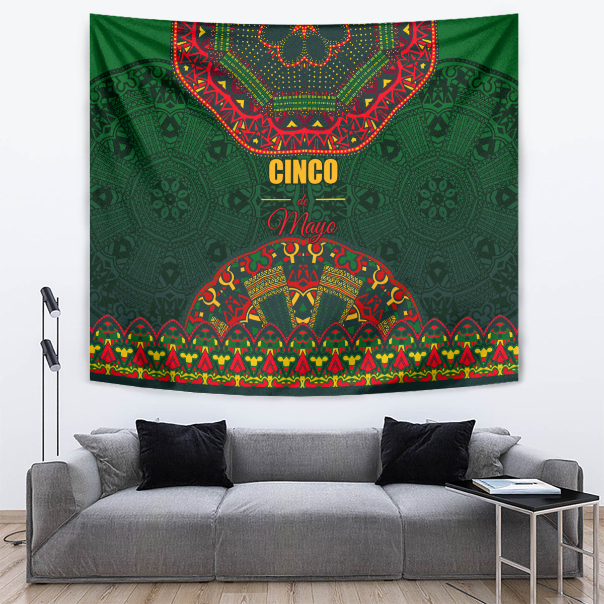 Green tapestry with Cinco May text and arched folk pattern in red, yellow, blue