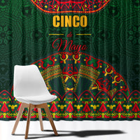 Green curtain with large 'CINCO de Mayo' lettering and colorful traditional pattern