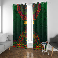 Green window curtains with colorful folk border pattern and hanging hooks at top