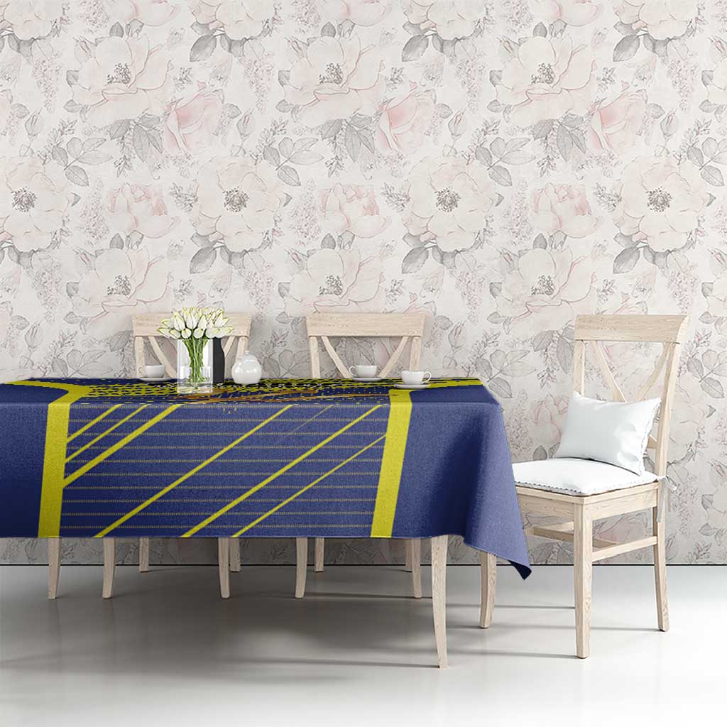 Blue and yellow football tablecloth featuring Barbados tridents emblem on dining setup