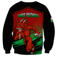 Red rugby sweatshirt with black sleeves, dragon graphic and "THREE FEATHERS" on front