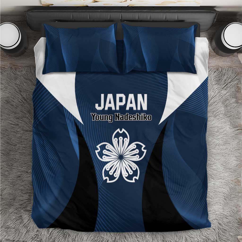 Blue duvet and black center panel with white “JAPAN” text and crest, two blue pillows