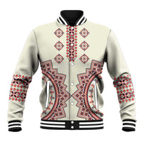 Beige baseball jacket with red and blue folk embroidery, snap front, ribbed collar and cuffs.