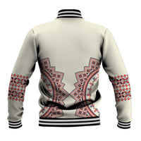 Beige baseball jacket back with large red and blue embroidered medallion and patterns, ribbed hem.