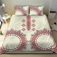 Beige duvet and pillows featuring red and blue ornate border patterns with central symmetrical emblem
