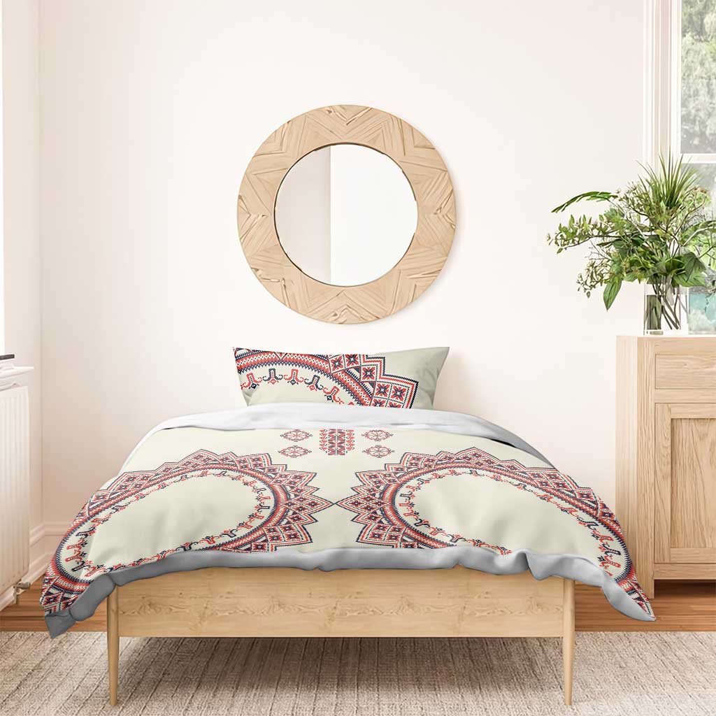 Beige duvet with red and blue oval medallion folk pattern and matching pillow featuring central motif