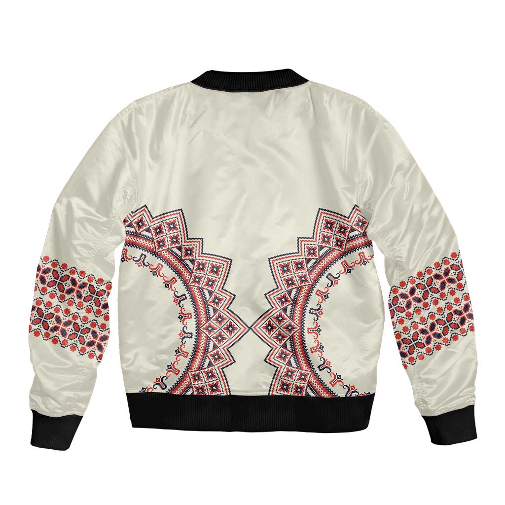 Beige bomber jacket with embroidered folk pattern back, black ribbed collar and cuffs