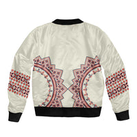 Beige bomber jacket with embroidered folk pattern back, black ribbed collar and cuffs