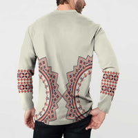 Beige button sweatshirt back view with large red-blue folk motif and patterned cuffs