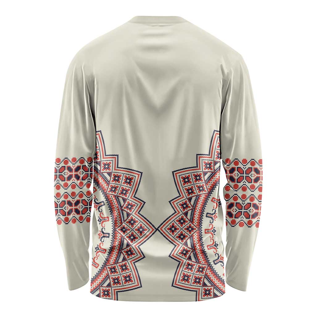 Beige long-sleeve shirt with red and blue folk pattern on back and cuffs
