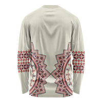 Beige long-sleeve shirt with red and blue folk pattern on back and cuffs