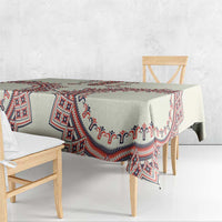 Beige tablecloth with red and blue border pattern and white accents