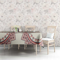 Beige tablecloth with red and blue traditional geometric pattern across table