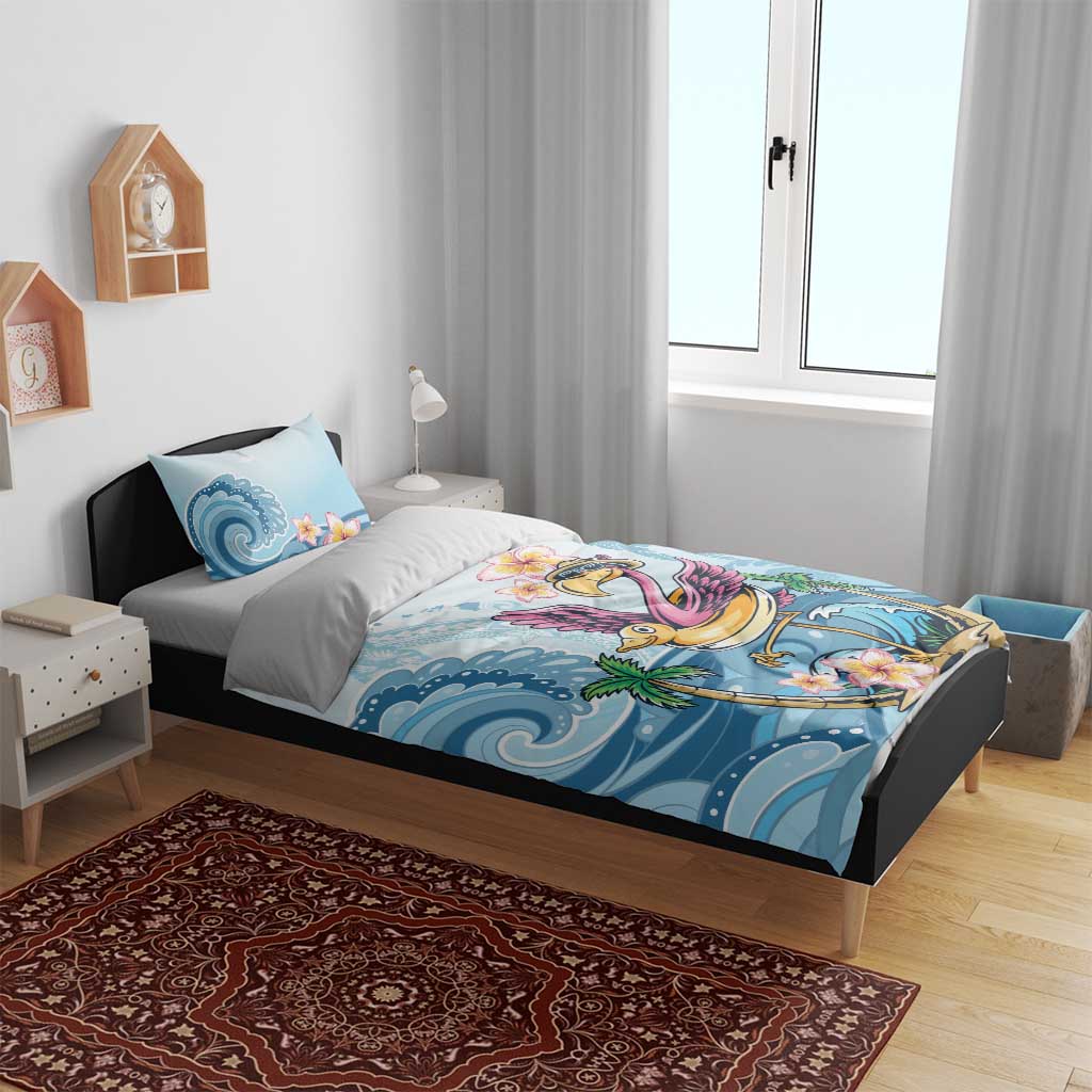 Blue flamingo bedding set on a bed with wave and flower prints, includes pillow cases