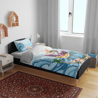 Blue flamingo bedding set on a bed with wave and flower prints, includes pillow cases