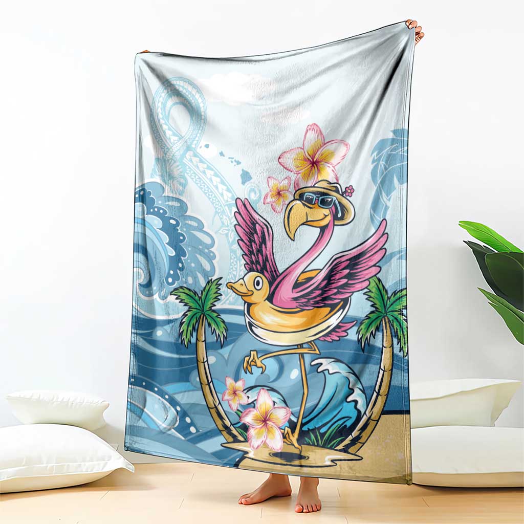 Tropical blue blanket with flamingo illustration and plumeria blossoms, draped over couch