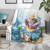 Blue flamingo blanket with plumeria flowers, spread on living room rug