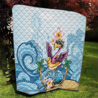 Blue tropical flamingo quilt close-up on outdoor lawn with wave and palm motifs