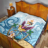 Blue tropical flamingo quilt on bed with plumeria flower and flamingo artwork