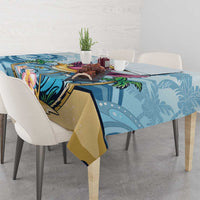 Blue tropical tablecloth with flamingo and palm leaf print, neatly draped on table
