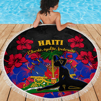 Round beach blanket showing Haiti emblem and red hibiscus flowers, black center, fringe trim