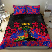 Haiti bedding set with black duvet and two red/blue hibiscus floral pillows, emblem center