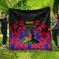 Black Haiti-themed quilt draped outdoors with red hibiscus flowers and Haiti text