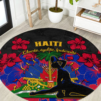 Black round carpet rug with Haiti lettering, red hibiscus flowers, vivid blue central art
