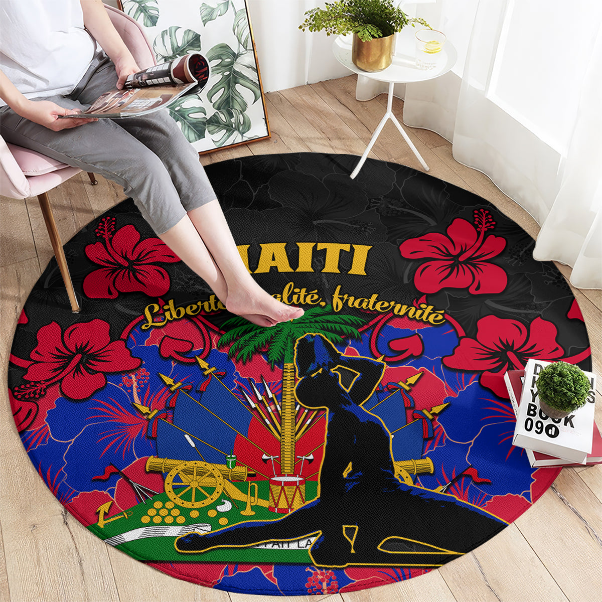 Black round carpet rug with bold Haiti text, red hibiscus, blue map-and-figures design