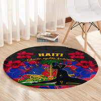 Black round carpet rug with Haiti lettering, red hibiscus details, vivid blue central artwork
