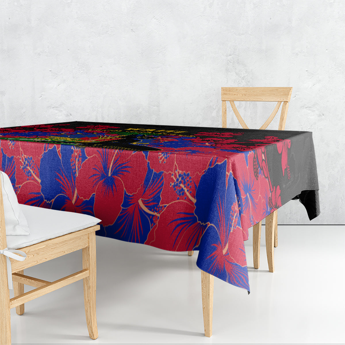 Black tablecloth with red and blue hibiscus pattern, draped over a dining table.