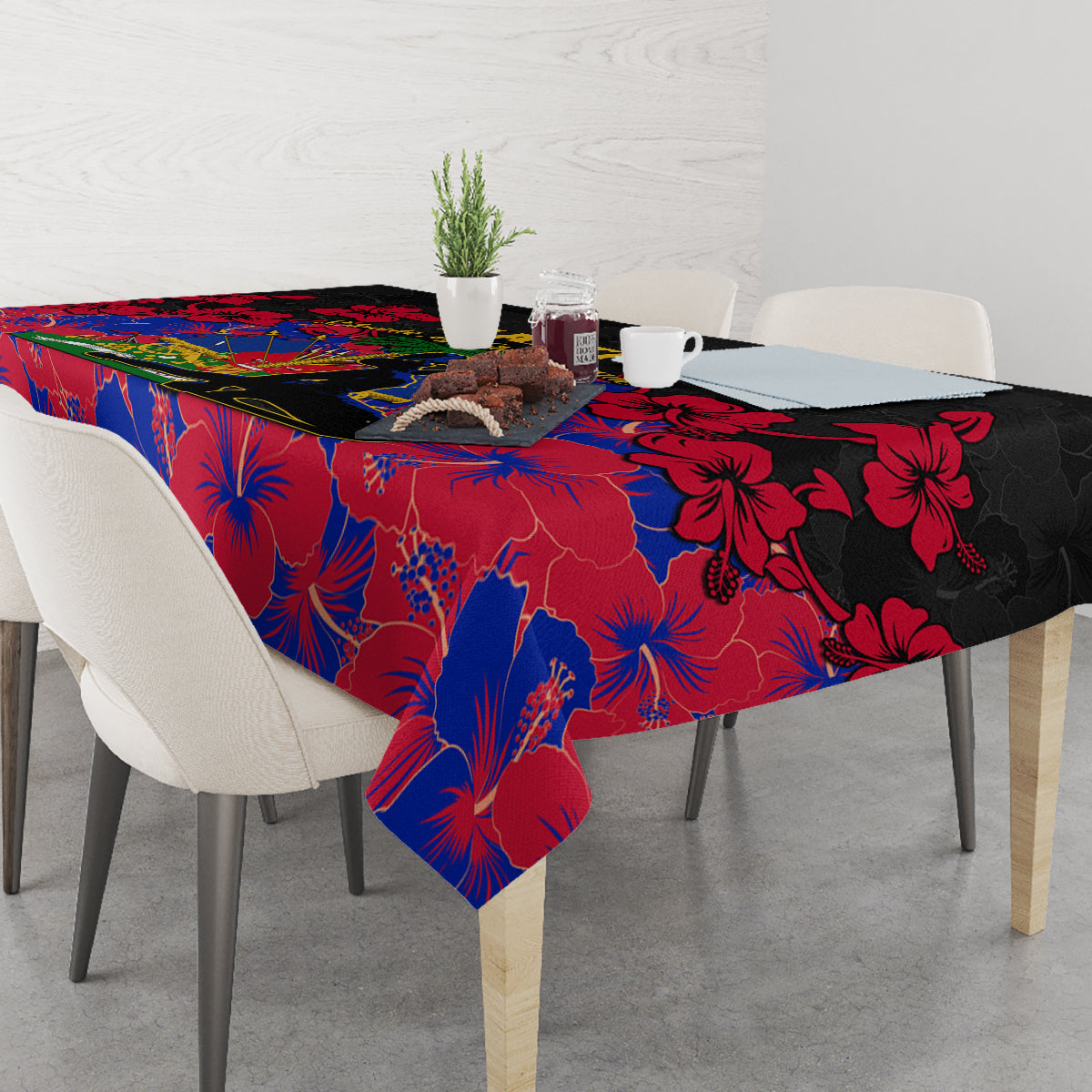 Black, red, and blue hibiscus print tablecloth with a hanging corner over the table.