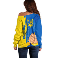 Back view off-shoulder sweatshirt in blue-and-yellow with vertical trident emblem, long sleeves