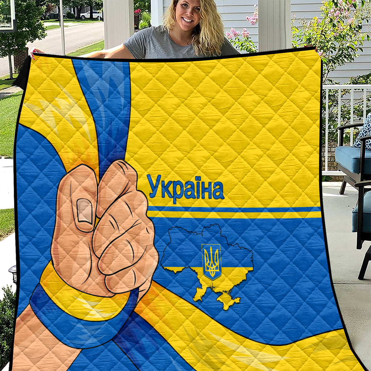 Quilted throw blanket with blue and yellow Ukraine flag design and peace-hand graphic