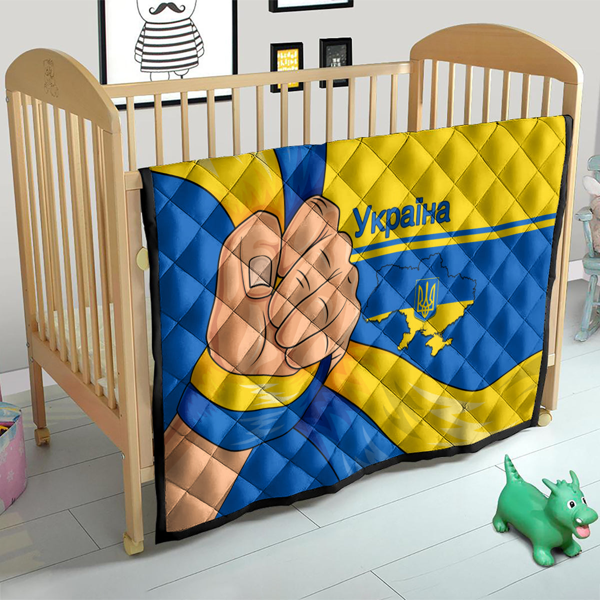 Quilted crib blanket with blue and yellow Ukraine flag pattern and peace-hand graphic