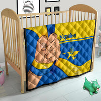 Quilted crib blanket with blue and yellow Ukraine flag pattern and peace-hand graphic