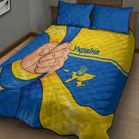 Blue and yellow Ukraine quilt bed set with quilted texture, fist graphic, map crest, two pillows.