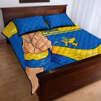 Blue and yellow Ukraine quilt bed set with fist artwork and crest in quilted diamond pattern.