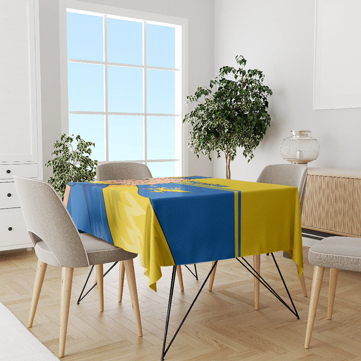 Ukraine Unity Day tablecloth on dining table with modern chairs, blue and yellow artwork